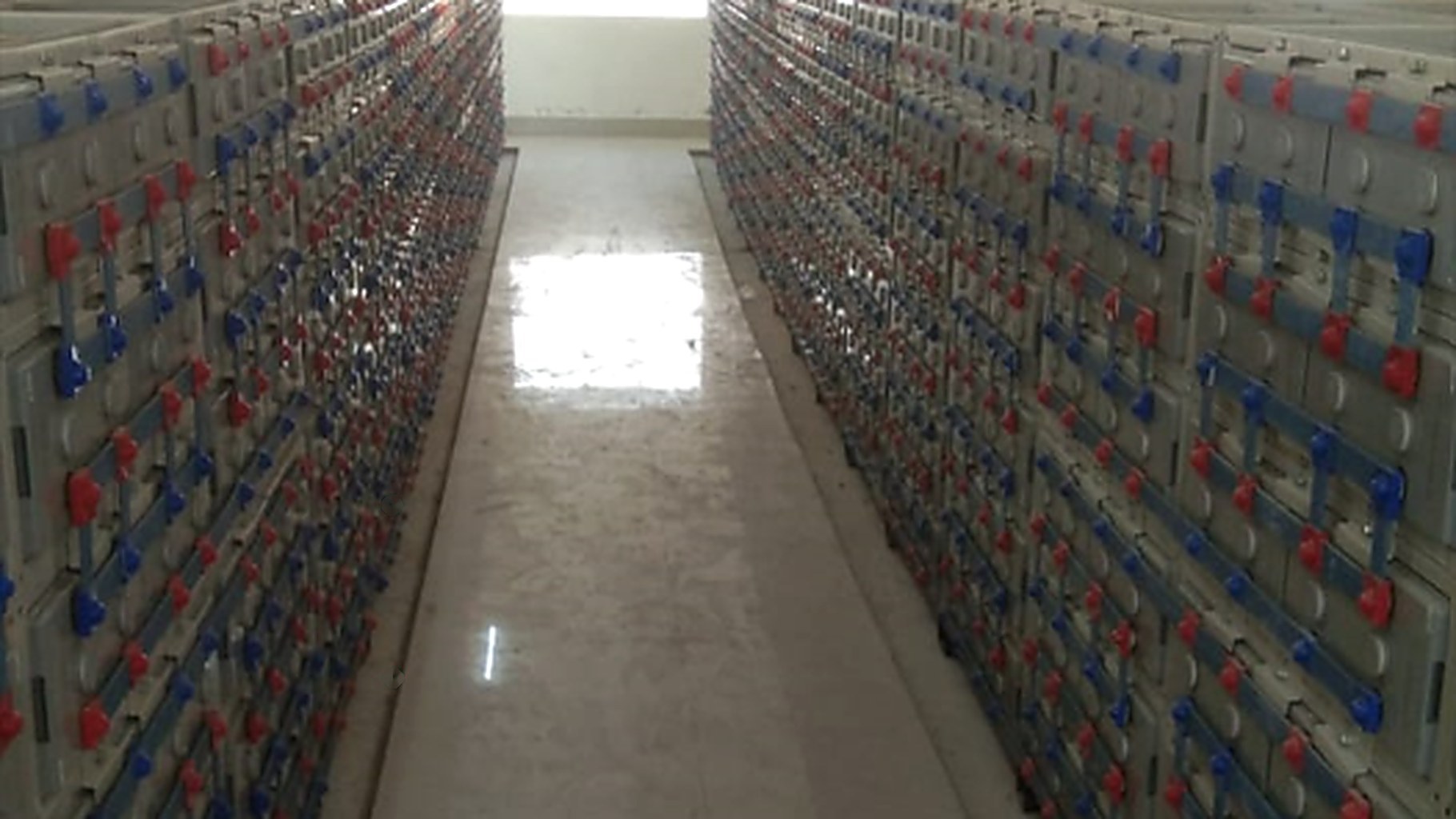 Rows of battery banks inside a storage room at an Indian industrial facility