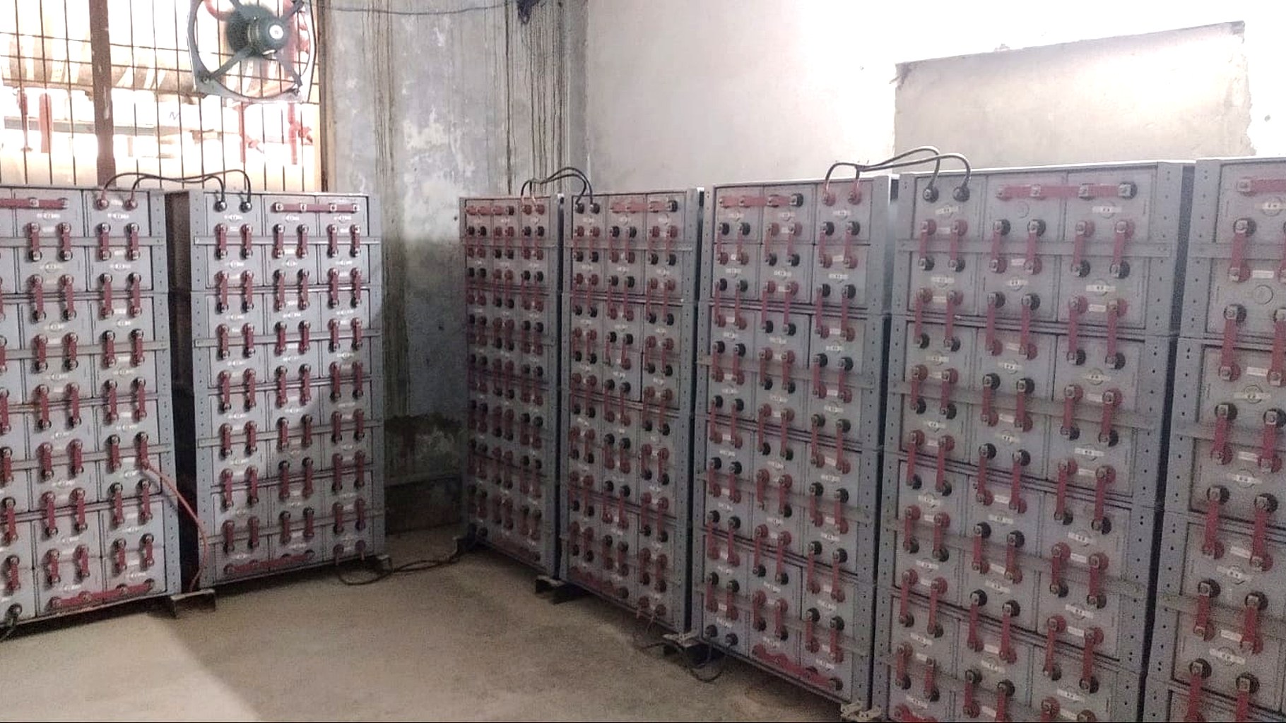 Battery bank in active service at an Indian industrial facility, with ventilation and protective enclosures, deployed by MGetEnergy as part of a hybrid microgrid