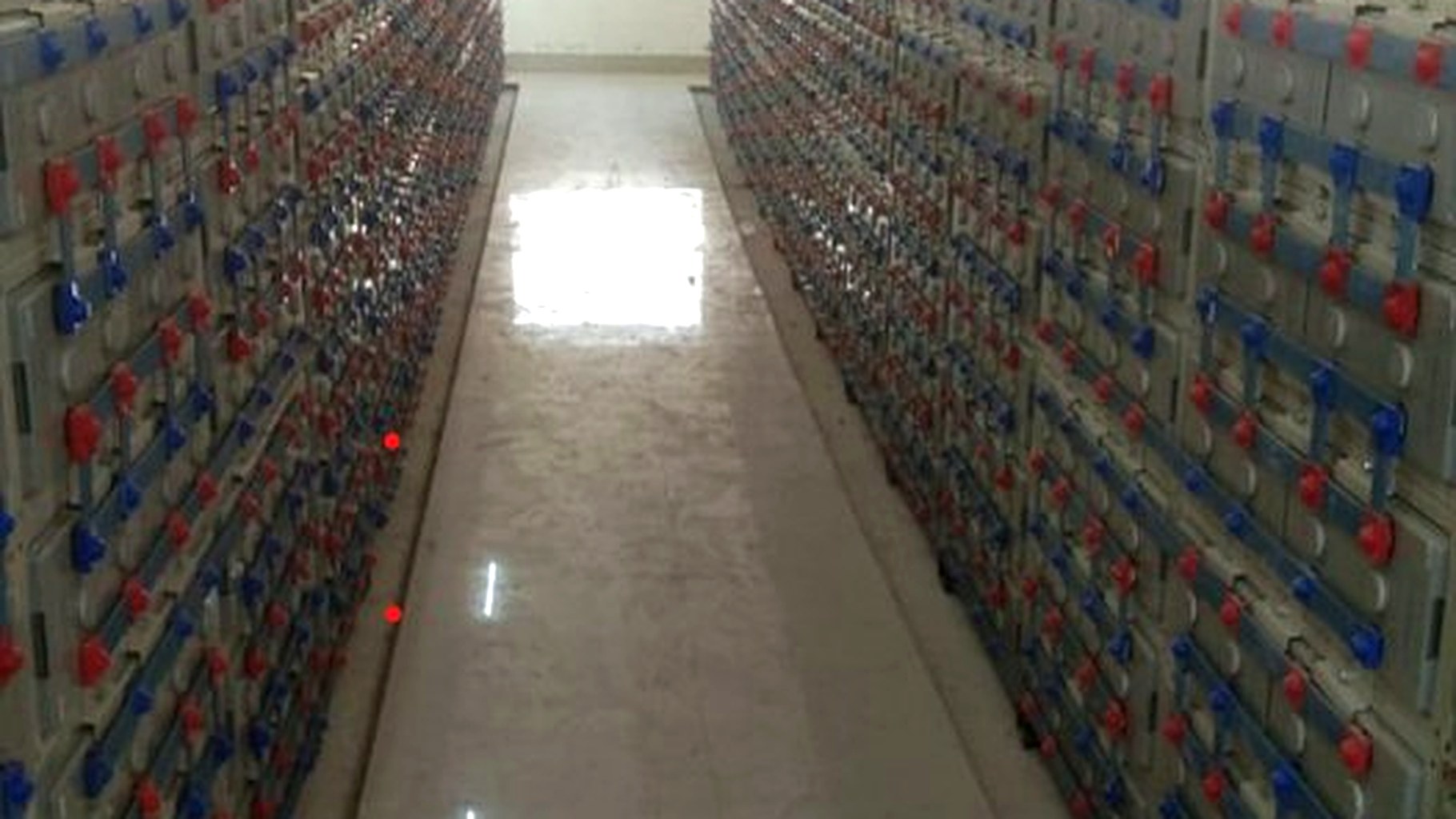 Industrial-scale BESS installation showing battery bank racked and cabled for a hybrid microgrid at an Indian C&I facility