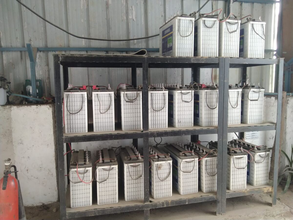 Twenty 12 V, 150 Ah batteries on steel racks forming the 240 V, 36 kWh battery bank at Adhiraj HP, Greater Noida