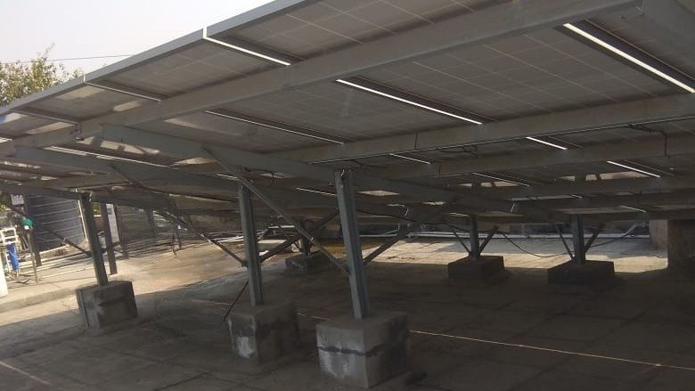 Elevated 40 kWp rooftop solar array on concrete blocks at GAIL's Madanpur Khadar LPG terminal, New Delhi